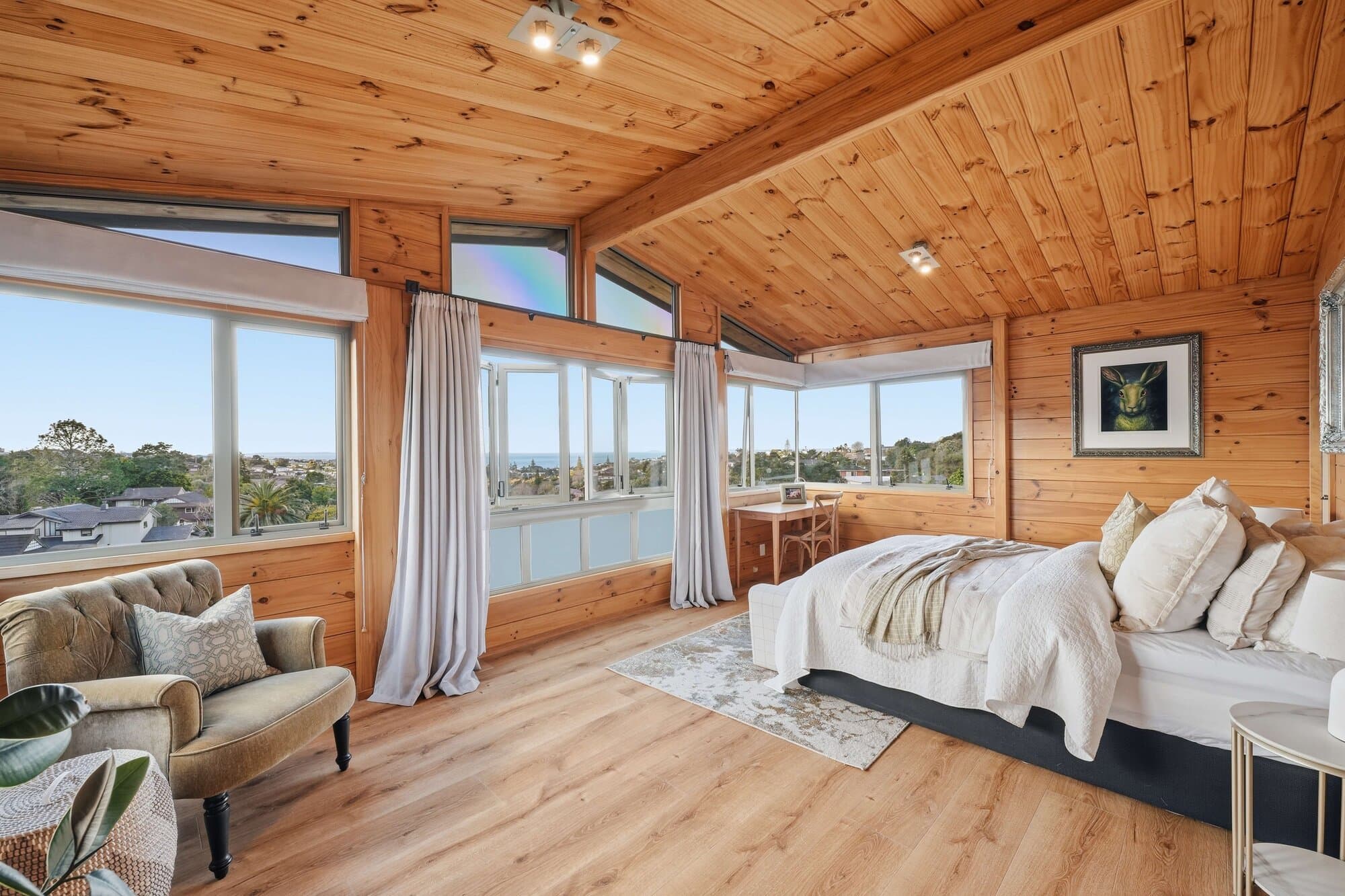 Bedroom with a timber ceiling and sea view