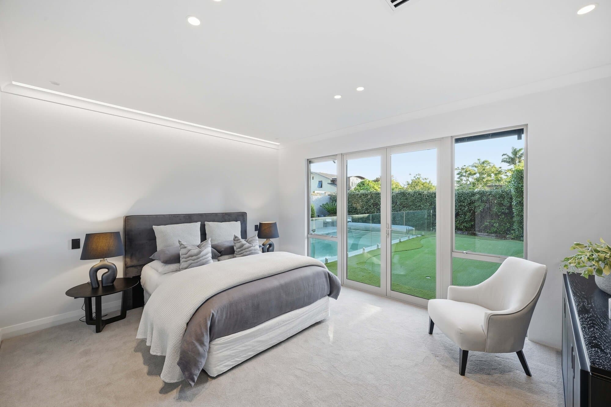 Primary bedroom with sliding doors opening onto the garden