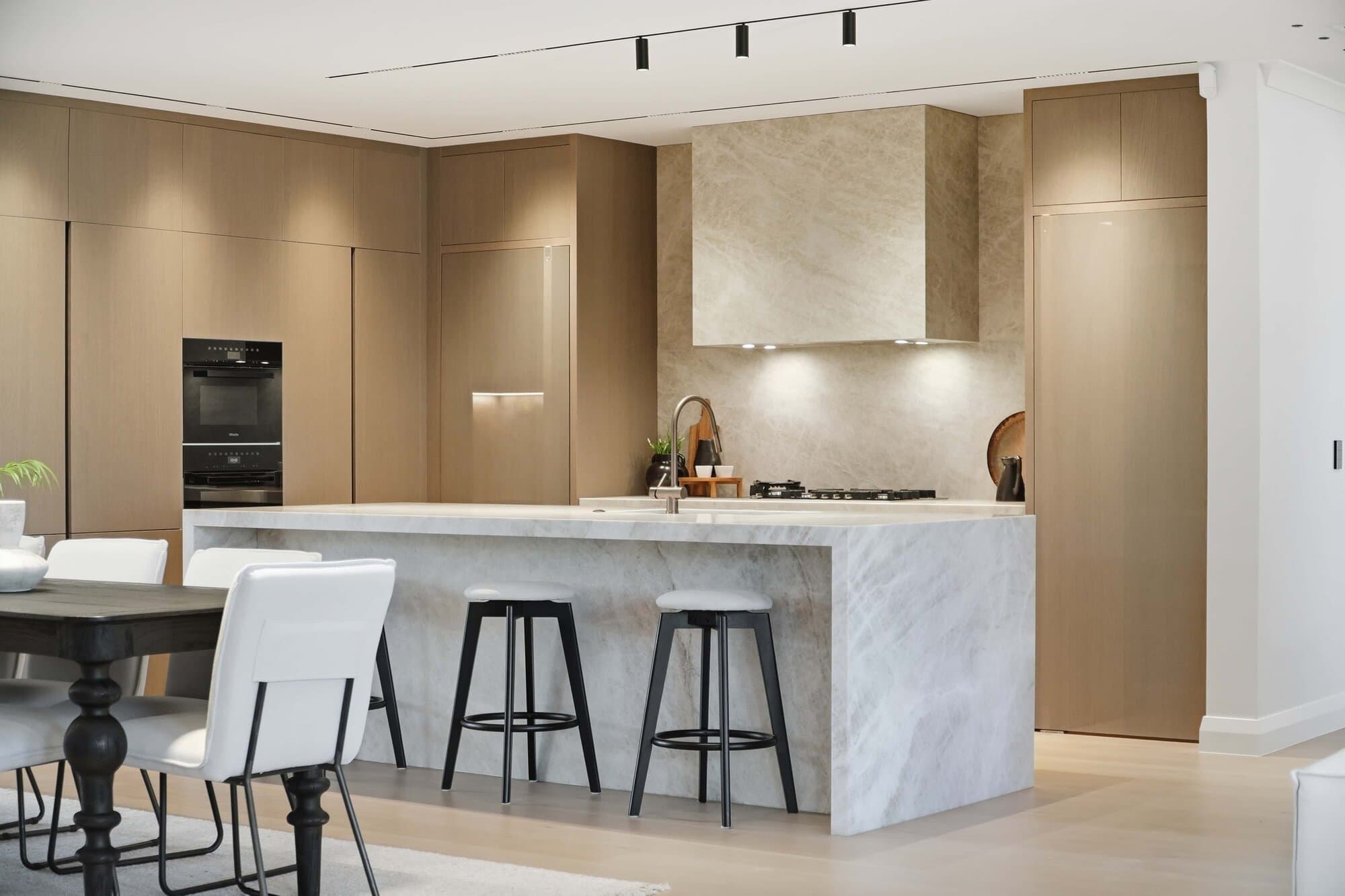 Kitchen with a marble waterfall island and bar seating