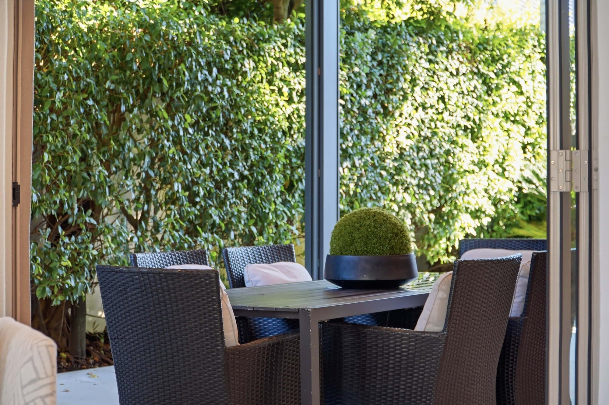 Outdoor lounge nook tucked among greenery