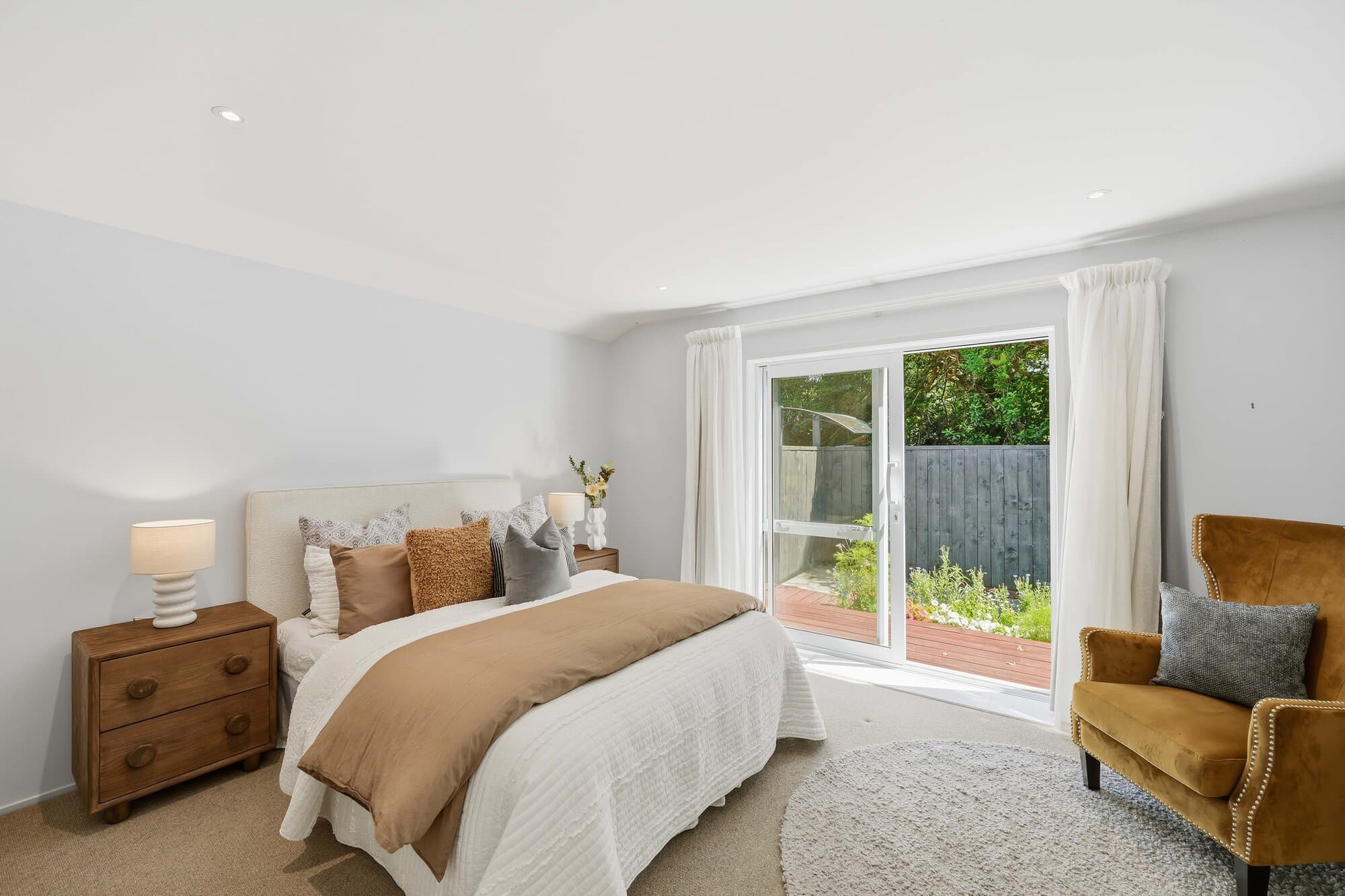 Bedroom in warm tones with glass doors