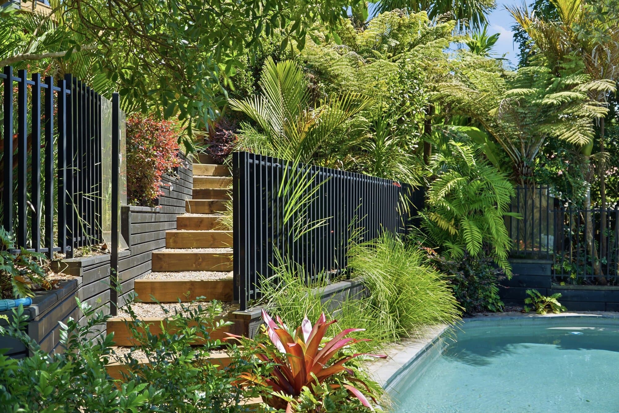 Pool steps surrounded by tropical garden