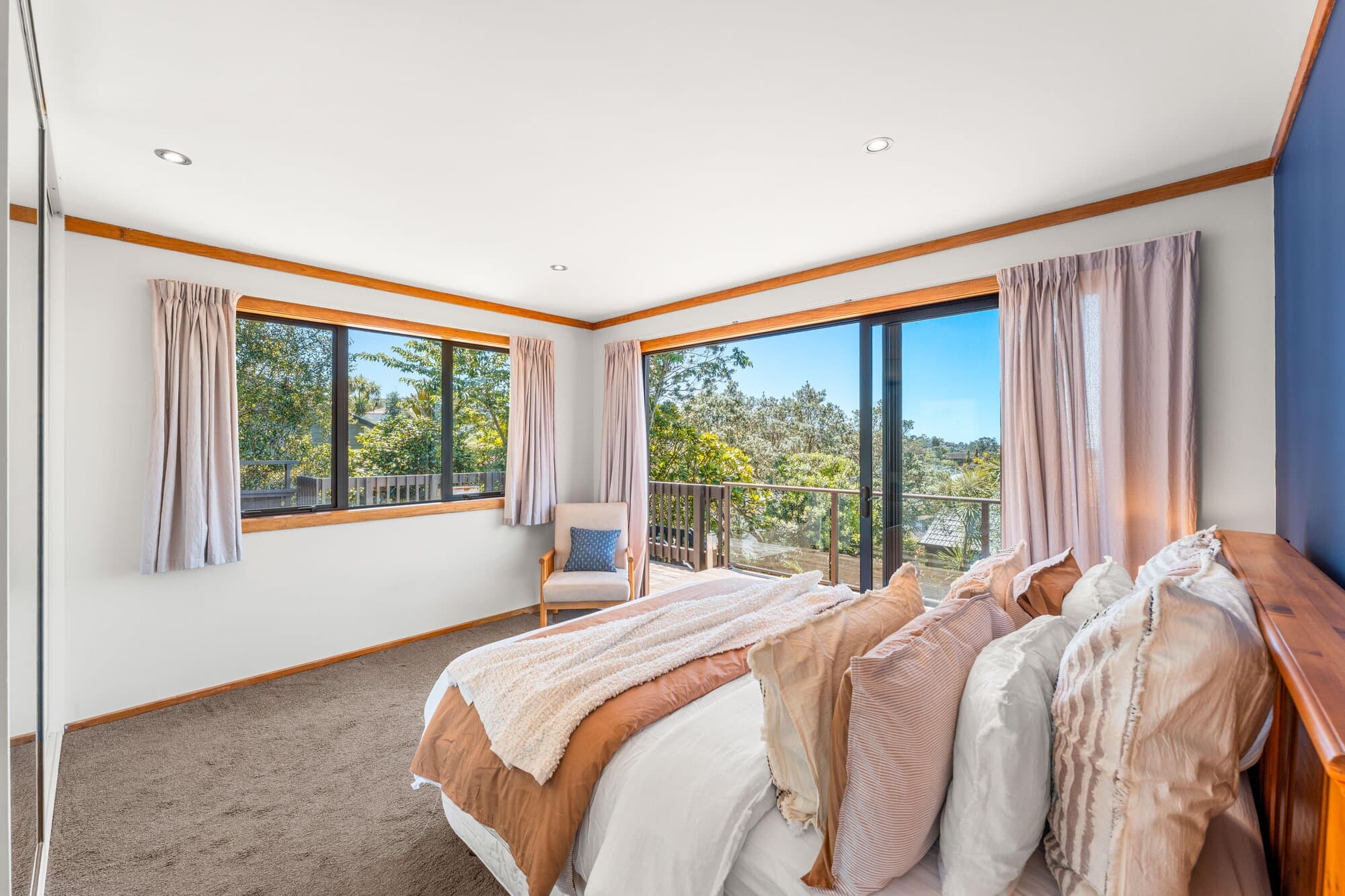 Bedroom with timber trim and a garden view