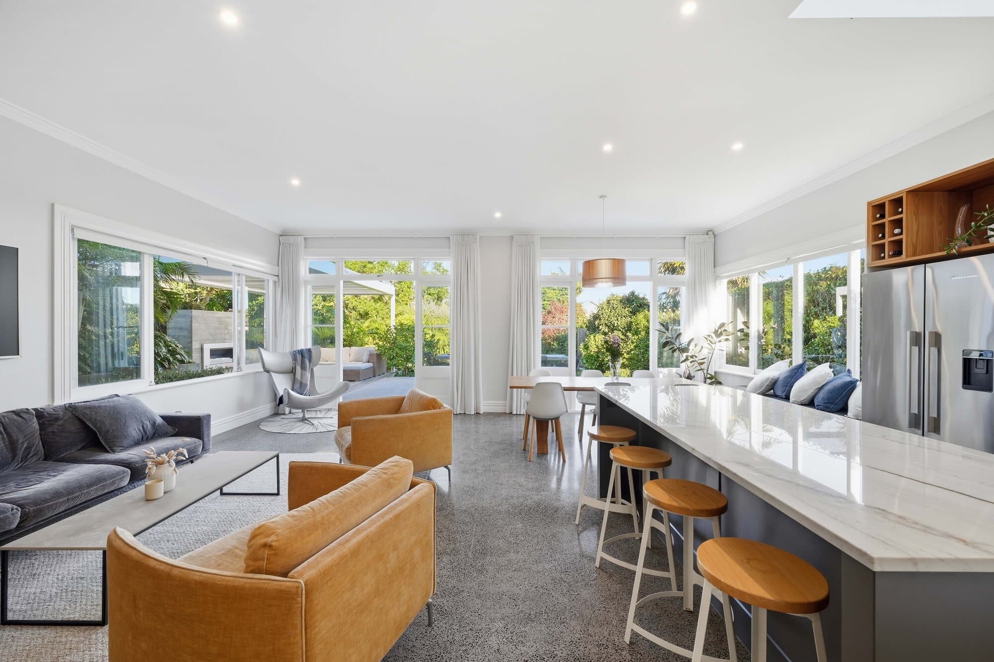 Kitchen and living space with timber accents beneath a skylight